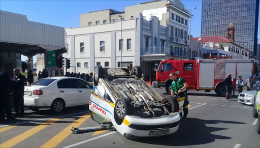 SUDDEN INVERSION: A BCM traffic vehicle lies upside down after being involved in a collision in Oxford Street yesterday. Several vehicles were damaged Picture: SUPPLIED