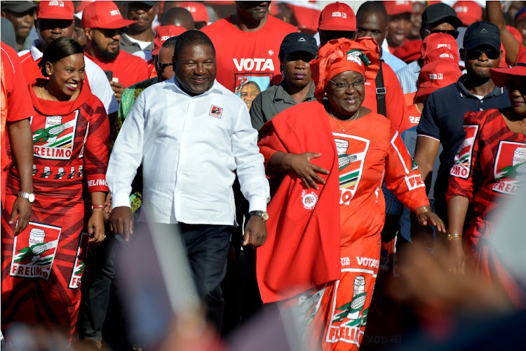 Mozambique's president and leader of ruling party Frelimo, Filipe Nyusi, and his wife Isaura Nyusi arrive to attend the final rally of their election campaign in Matola, Mozambique, on October 12 2019.
