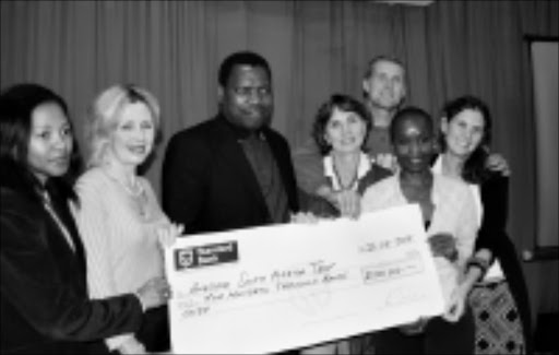 WINDFALL: MEC for finance Zweli Mkhize, centre, donates R500 000 to Awesome SA, the organisers of the Wonderful Women gathering. From left, Pam Zulu, Sandy Holley, Di Smith, Nosipho Mgojo, Candy Smith and Garth Braudseth. Pic. Mhlaba Memela. 26/08/08. © Sowetan.