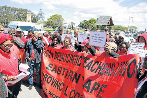 EQUAL PAY: A handful of Sadtu protesters gather outside Buffalo City College yesterday Picture: SISIPHO ZAMXAKA