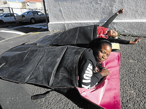 Amanda Pepile and Zonke Baninzi, who have been living on the streets in the Cape Town CBD for more than 10 years, try out sleeping bags made from advertising billboards that would otherwise go to landfill. Street Sleeper, which makes the sleeping bags, aims to 'transform the negative impact of waste into immediate relief of those living on the street'