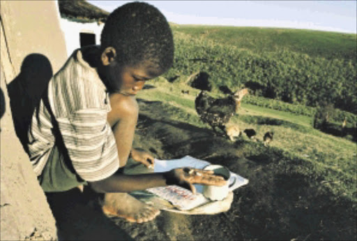 Two months after starting his antiretroviral treatment for AIDS, orphan Zamokuhle Mdingwe, 7, takes the pills as he does every morning and evening. At this point his health was improving and he was feeling a lot better than when he started taking medication. Zamo's mother had died nine months earlier from AIDS-related infections. Zamo was being cared for by his elderly grandparents. His drugs were being provided by the Siyaphila La ("We are living here") HIV-treatment programme, which is making antiretroviral treatment easily available in this poor, rural district.