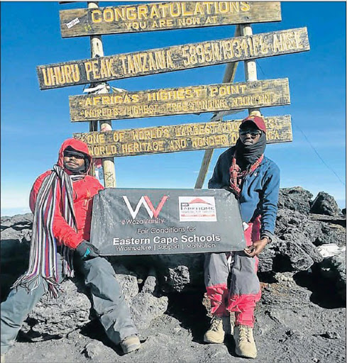 SIGNING OFF: Motivational speaker Welile Mbolekwa summited Mount Kilimanjaro on a campaign he called ‘Fair conditions for Eastern Cape schools’. He is seen here with mountain guide William Fidelis