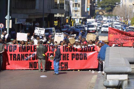 FLASHBACK: SAMWU members march in Johannesburg. 28/03/07. South African Municipal Workers Union (SAMU) members march in downtown Johannesburg as part of a national strike over a pay rise dispute. As a mark of protest they systematically trash the city. 5/7/02. Pic. by Sydney Seshibedi. © ST.