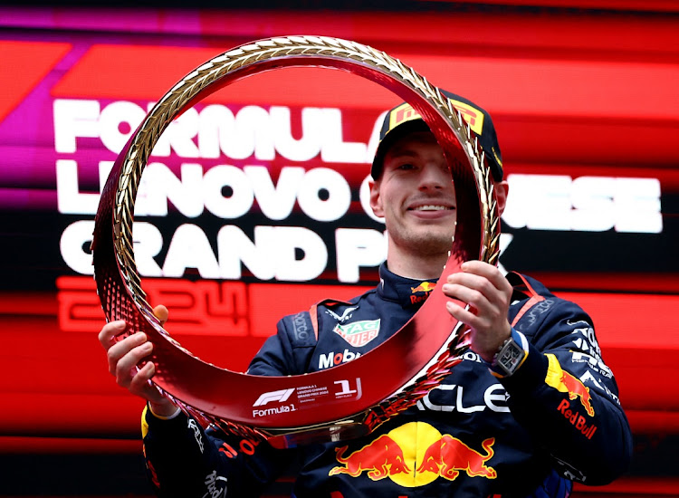 Red Bull's Max Verstappen celebrates on the podium after winning the Chinese Grand Prix at Shanghai International Circuit on April 21, 2024