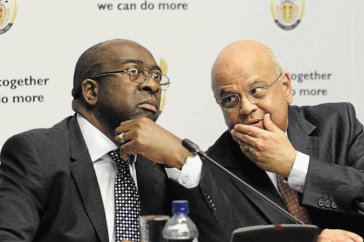A WORD IN YOUR EAR: New Finance Minister Nhlanhla Nene, left, and predecessor Pravin Gordhan. Nene is known to agree with the former minister's macroeconomic philosophy