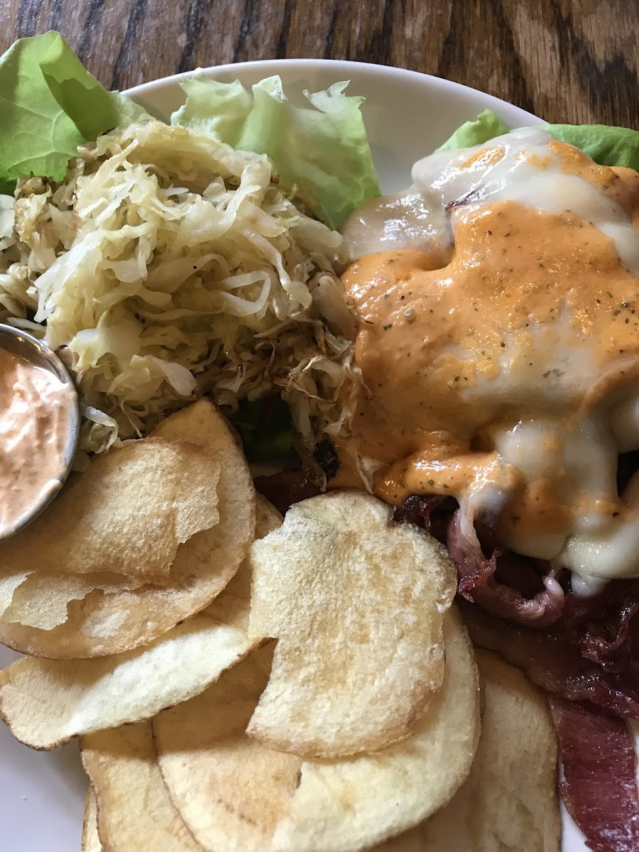 Ruben “Sandwich” (no bread) on a bed of lettuce with extra sauerkraut and housemade potato chips