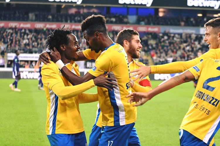 SA international forward Percy Tau (L) is congratulated by his Royale Union Saint-Gilloise teammates after setting up their opening goal in a stunning shock 3-0 cup win over Belgium giants Anderlecht on Thursday September 27 2018.