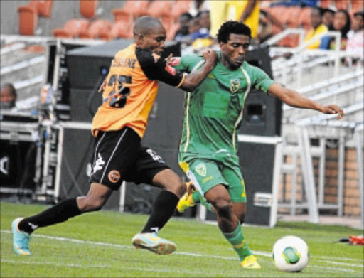 LEAVE IT TO ME: Mzivukile Tom of Golden Arrows is challenged by Tlou Molekwane of Polokwane City during their recent league match at Peter Mokaba Stadium Photo: Gallo Images/Phillip Maeta
