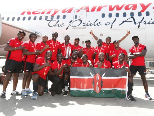 The Kenya Rugby sevens team poses for a photo at Jomo Kenyatta International Airport in Nairobi, upon returning from Singapore where they won the main cup title of the World Rugby Sevens Series, April 19, 2016. Photo/PIC-CENTRE