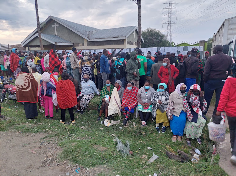Voters at Christian Outreach Church polling Station in Kwa Rhonda in Nakuru Town West sit stranded after the church management locked them out.