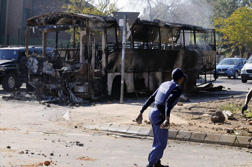 June 21, 2016. A delivery truck and a bus were set alight by angry residents of Atteridgeville, west of Pretoria. Residents brought the township to a standstill following the announcement that Parliament House Chairperson Thoko Didiza will be the mayor of Tshwane should the ANC retain the municipality later this year. Police later arrived to clean the streets while looting continued. PHOTO:PETER MOGAKI