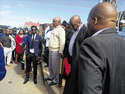 MOURNING: Buffalo City Metro deputy mayor Xola Pakati hangs his head at the scene where a municipal worker was injured and later died Picture: ZWANGA MUKHUTHU