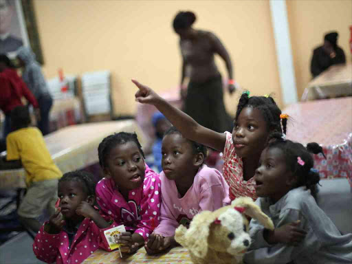 Haitian migrants watch TV inside Padre Chava shelter after they left Brazil, where they relocated after Haiti's 2010 earthquake, but have decided to move to the US, in Tijuana, Mexico, October 3, 2016. /REUTERS