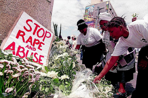 Women place white flowers outside parliament during a demonstration in Cape Town. South Africa has a high incidence of rape with more than 50 000 reported per year.