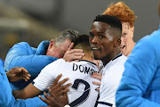 Bidvest Wits forward Haashim Domingo celebrates with head coach Gavin Hunt and teammates after forcing an own goal off Gladwin Shitolo in their 1-0 Absa Premiership away win against Orlando Pirates at Orlando Stadium on August 15, 2018 in Johannesburg, South Africa.