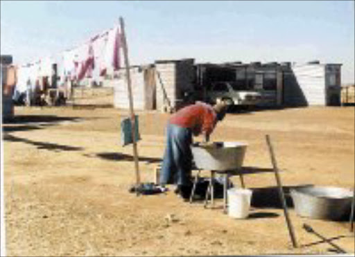 MISERY OVER: Edith Ntombela sold her house to buy another properety but ended up in this shack. 01/08/07. © Sowetan.