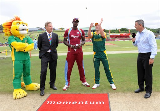AB de Villiers of South Africa tosses the coin with Jason Holder calling during the 3rd Momentum ODI between South Africa and West Indies at Buffalo Park on January 21, 2015 in East London, South Africa.