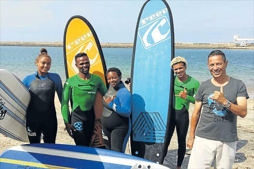 BUILDING TRUST: Waves for Change coaches Rachel Mather, Lukhanyo Xenti, Sibulele Krwempe, Jose Peffer and manager JD van der Walt teach children affected by violence to surf as a means of therapy Picture: BARBARA HOLLANDS