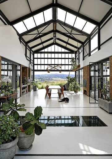 The central conservatory is a dramatic reinterpretation of the stoep common in SA homes, but rather than being pinned to the front of the house, it becomes its core.