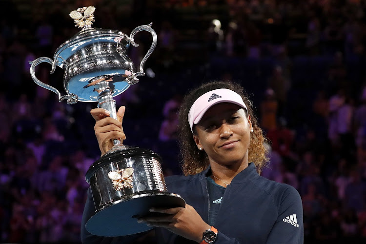 Japan's Naomi Osaka poses with her trophy after winning her match against Czech Republic's Petra Kvitova.