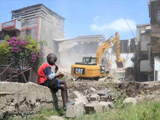 An excavator demolishes buildings in Nyama Villa estate, Kayole, on December 18 last year /VICTOR IMBOTO
