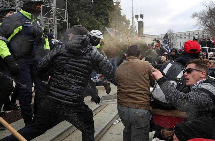 U.S. Capitol Police use pepper spray as a mob of supporters of U.S. President Donald Trump also use pepper spray against the police as they storm the U.S. Capitol Building in Washington, U.S., January 6, 2021.