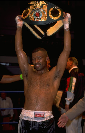 Mpush Makambi of South Africa holds up his championship belt after his fight against Adrian Dodson held at Bethnal Green, London.
