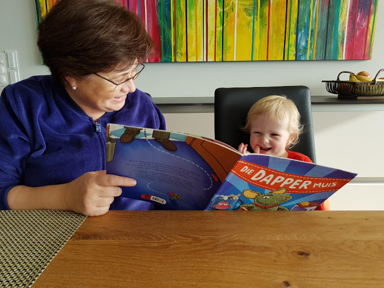 Wilhelmien van Nieuwenhuizen reads to her grandson Lukas Koorts, who was two-and-a-half when he last spent time with her. He is now four, their bond has weakened over time and their upcoming family holiday has been cancelled.