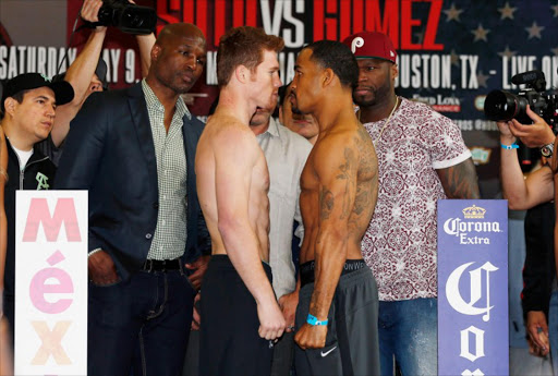 Canelo Alvarez of Mexico and James Kirkland pose on stage alongside promotors Bernard Hopkins and 50 Cent inside the Union Station lobby after their weigh-in inside prior to their super welterweight bout tomorrow at Minute Maid Park on May 8, 2015 in Houston, Texas. 50 Cent's company SMS Productions filed for bankrupcy on May 25, 20015.