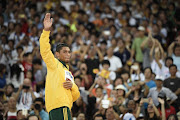South Africa's gold medallist Wayde van Niekerk waves on the podium during the victory ceremony for the men's 400 metres athletics event at the 2015 IAAF World Championships at the 