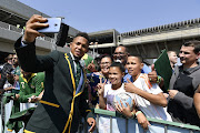 Springbok player Elton Jantjies meet fans during the South African national men's rugby team official send-off at OR Tambo International Airport on August 30, 2019 in Johannesburg, South Africa. 