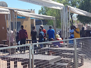 This queue at Busy Corner in Thembisa is for a bank ATM - local polling stations remain empty.