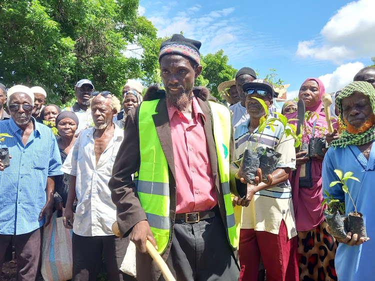 Hamisi Mwajao leads the community in planting trees to restore degraded Kaya Tiwi Forest land in Kwale county on May 4, 2024.