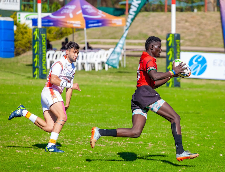 Kenya Under 20 fly-half Jackson Siketi edges past his Tunisian opponent during the Barthes Cup match in Harare on Wednesday