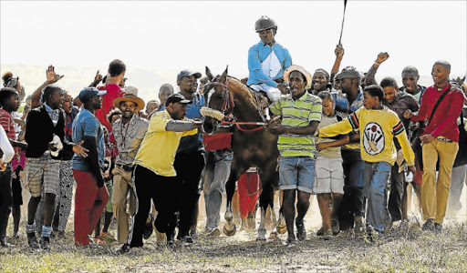 SITTING PRETTY: The crowd is all excited at the performance of the jockey and his mount at a Berlin November race. A well groomed horse will be a key factor in this annual event