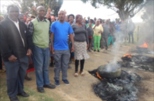 SEPTEMBER 5;2016: ANGRY: Gxididi headman Hamilton Sithonga, resident and former UDM councillor Zola Luyenge and Solomzi Mdutyulwa were among Gxididi residents who staged a protest by burning tyres and blocking a gravel road cutting through the area.They accuse Luyenge's younger brother and ANC MP Zukile Luyenge of trying to hijack a project to build a community hall in the area by KSD municipality.
