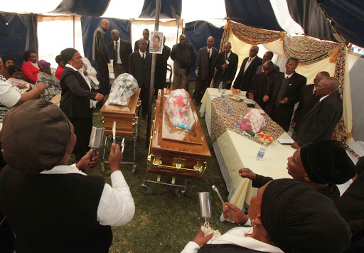 FAREWELL: Mourners sing as they pay their last respects to Nonzwakazi Nkohla and her three-year-old daughter Amile Owam Nkohla at were burial at Gwali Village in Tsolo on Saturday Picture:LULAMILE FENI