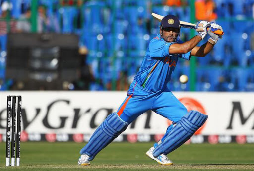 MS Dhoni of India hits the ball towards the boundary during the 2011 ICC World Cup Warm up game between India and Australia at the M. Chinnaswamy Stadium on February 13, 2011 in Bangalore, India