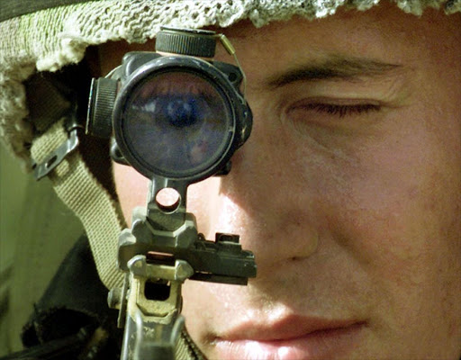 File picture of a soldier aiming through a sniper rifle