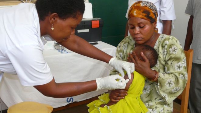 A nurse administers a malaria vaccine to a child during trial in 2021.