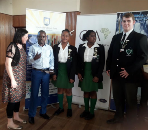 WORTHY WINNERS: At the debate evening are, from left, Cambridge head of debating and English teacher Claire Gawler, Community Action Africa director Musa Sebugwawo and the winning Cambridge team of Asivile Loki, Vanessa Annan and Daniel Rothmann Picture: SUPPLIED