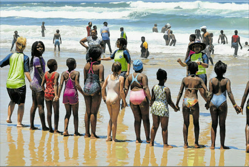 SAFETY FIRST: Yona Balindlela (in front of the children with a sunhat on) teaches them about water safety Picture: RANDELL ROSKRUGE