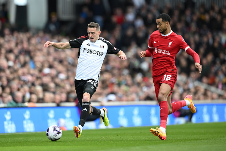 Timothy Castagne of Fulham runs with the ball while under pressure from Cody Gakpo of Liverpool during the Premier League match between Fulham FC and Liverpool FC at Craven Cottage in London, England, April 21 2024. Picture: Justin Setterfield/Getty Images