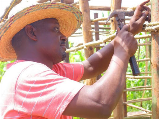 Rarieda MP Otiende Amollo when he joined residents of his constituency to construct a house for a widow on Friday, May 12, 2018. /COURTESY