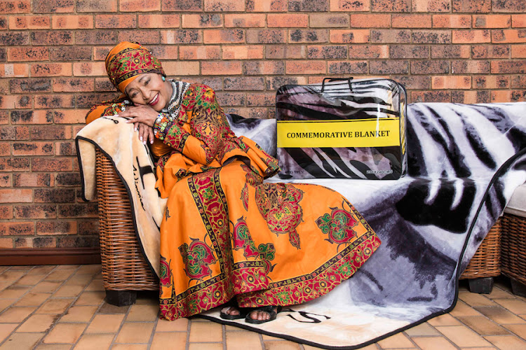 Struggle hero Winnie Madikizela-Mandela poses with the Commemorative Blanket.