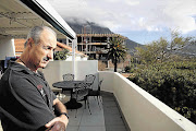 COMPLAINANT: Bernardino Faias watches helplessly from his balcony in Vredehoek as the seven-storey block of flats goes up. Faias and five of his neighbours have gone to court to stop the construction, which they claim will devalue their properties and obscure their view