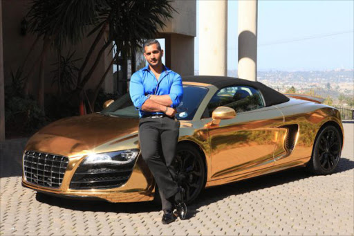 Rajiv in happier days next to his gold wrapped Audi R8 Picture: JACKIE CLAUSEN