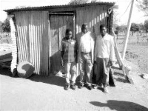 DESTITUTE: Vusi Ndlovu, 16, and his brother Thulani, 14, with Bennet Nkuna, principal of Makhuva Primary School, who has looked after the boys. Pic. Victor Hlungwani. © Sowetan.