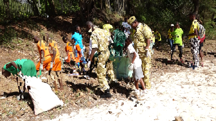Malindi security officials join stakeholders in the clean-up exercise.
